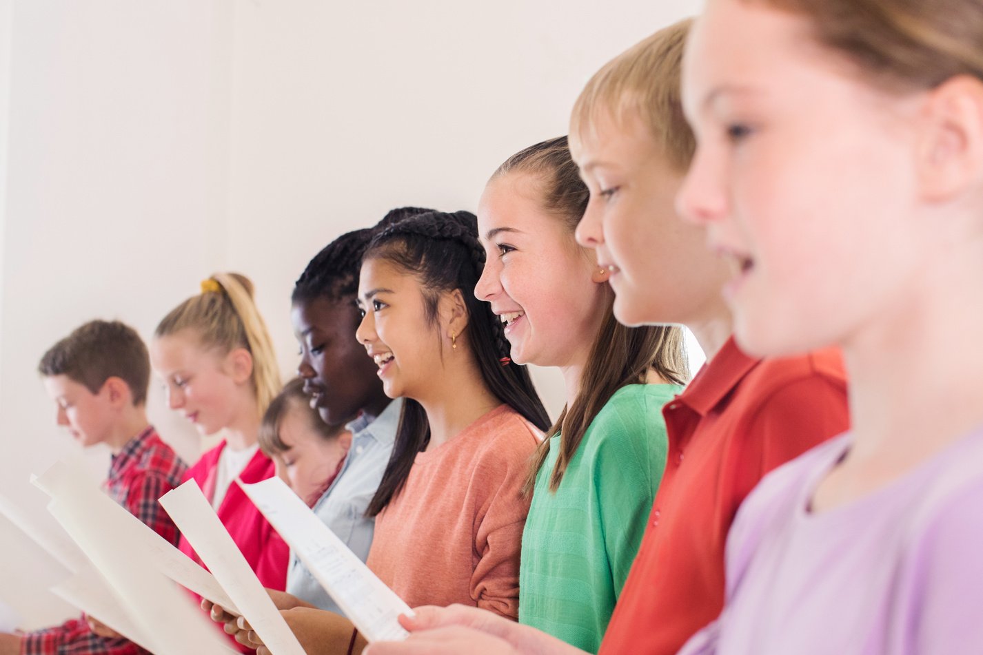 Group Of School Children Singing In Choir Together